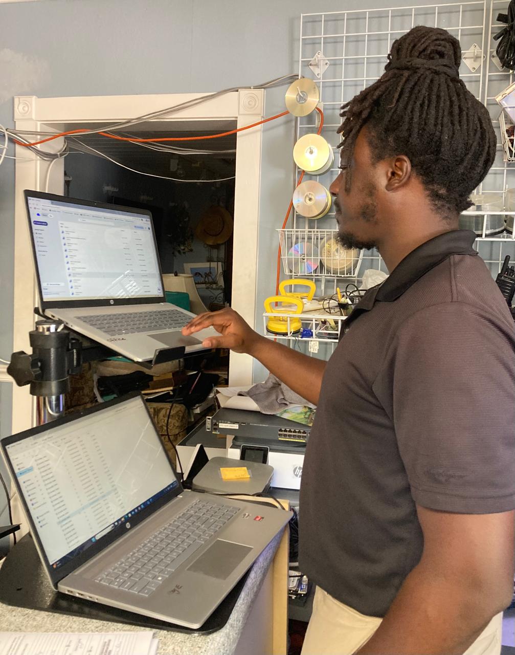 A person working with laptops at the shop