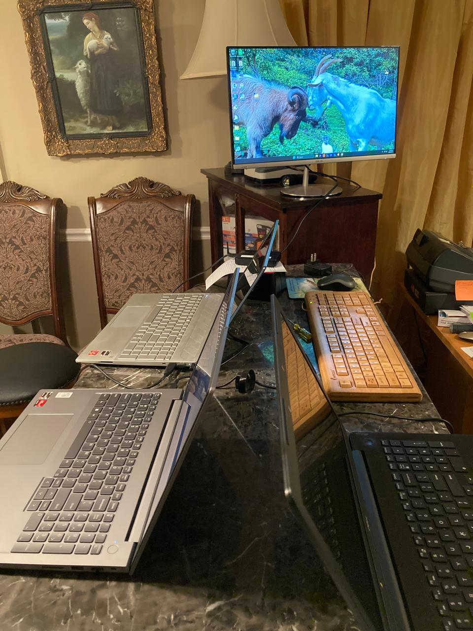 Laptops and an external monitor set up on a table